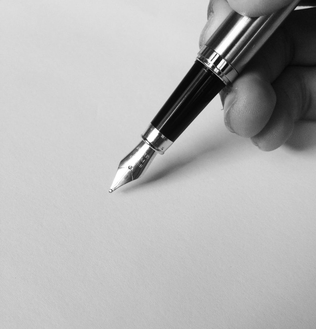 person holding fountain pen